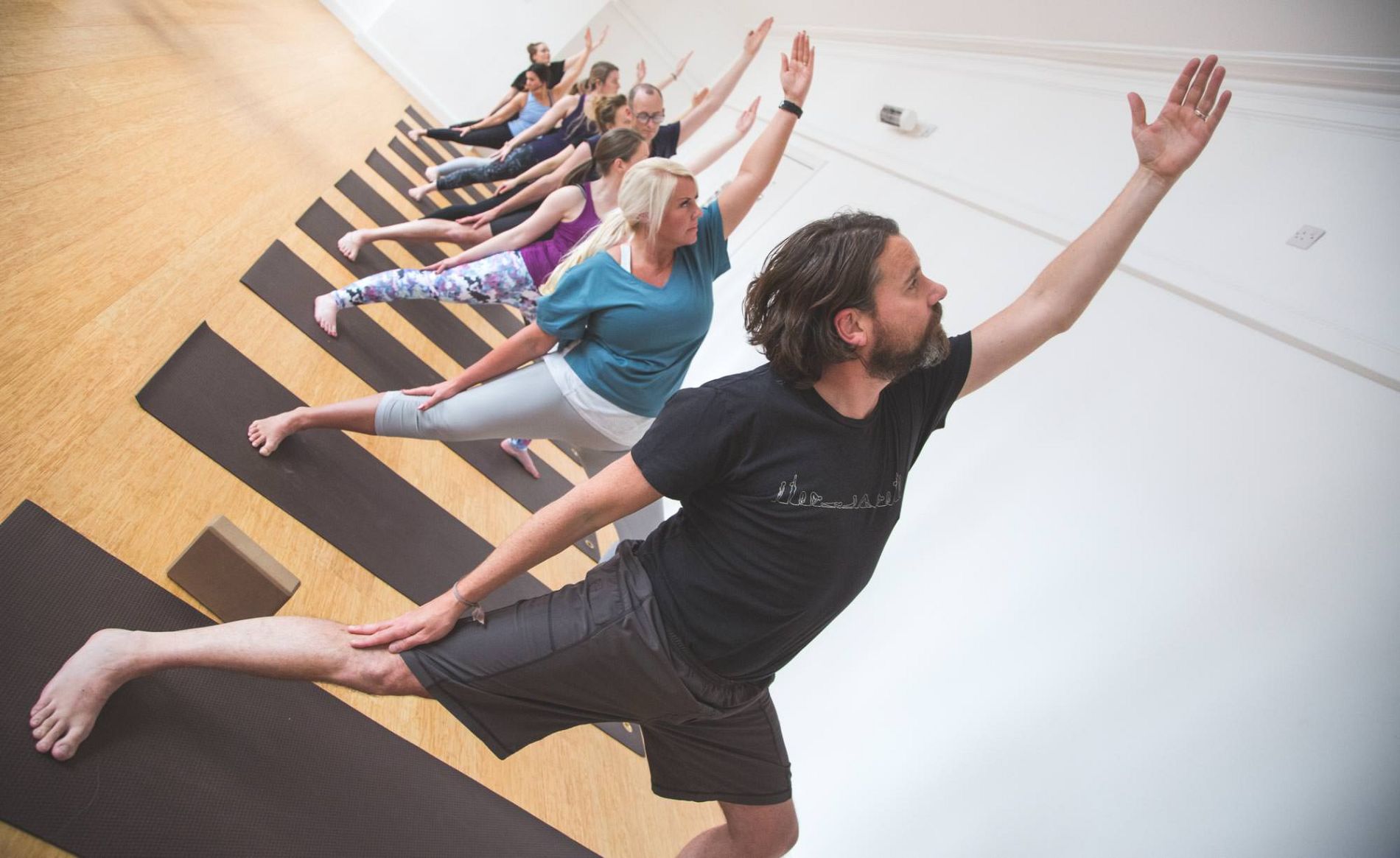 Students moving together in a seasonal flow class